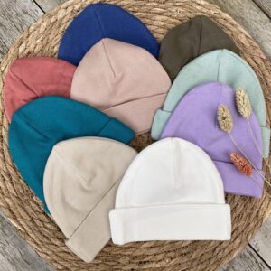 Verschilende kleuren babymutsjes om naam erop te borduren - detail